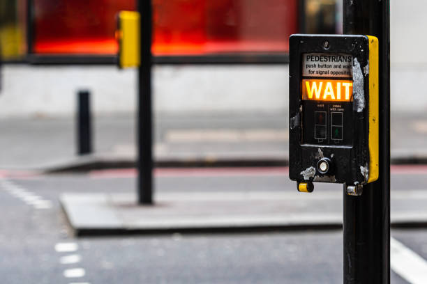 Crosswalk button for pedestrian with light warning on a defocused background , London, UK - image