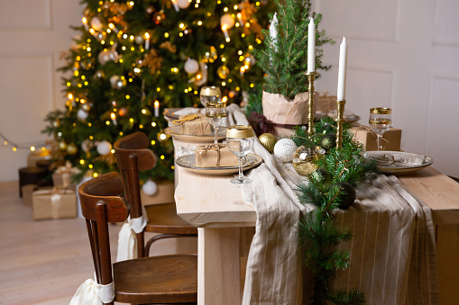 Christmas or New Year festive table setting. Glass of champagne on the table.