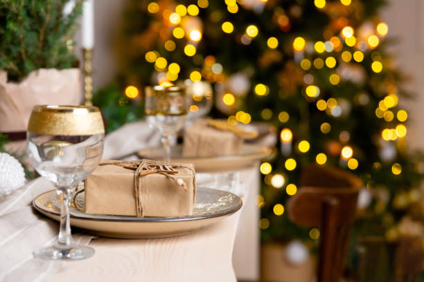 istock Christmas or New Year festive table setting. Christmas present in a plate on the table 1269622333