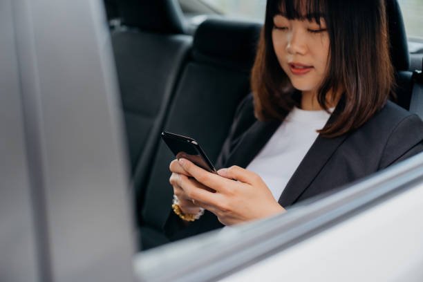 istock Young asian businesswoman using smartphone in car 1269622485