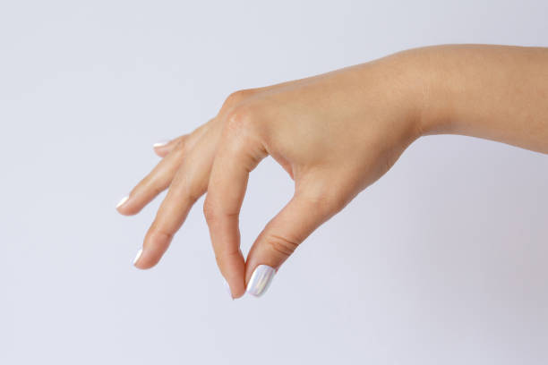 istock A woman's hand is holding something. Some object is hanging in the hand. Hand gesture and symbol. Sign language 1269622683