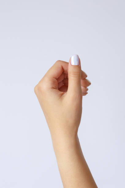 Gesture and sign, hand holds something on a light background