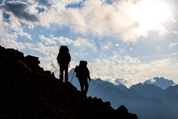 istock hikers silhouette on a mountain slope 1269626799