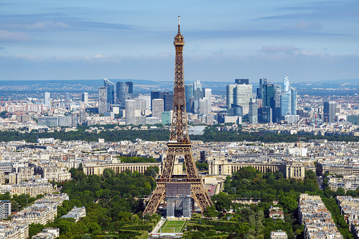 paris cityscape with iconic eiffel tower in the center under blue sky.