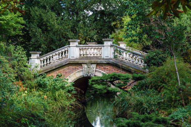 istock Stone arch bridge over a stream in the Parc Monceau - Paris, France 1269628708