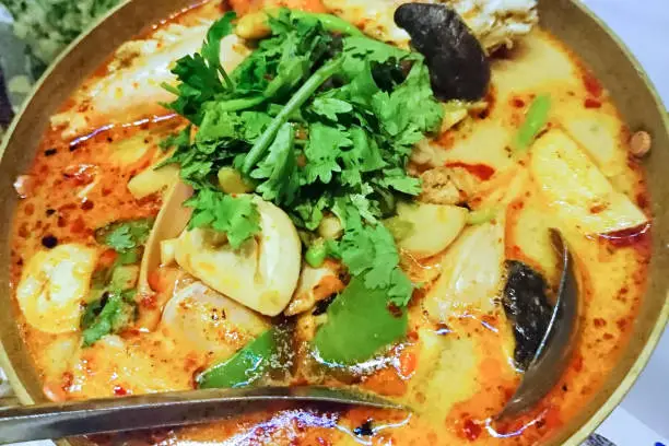 Tom means boiled, yum is a sour and spicy Thai salad and kung means prawn. Aside from the prawns, the primary ingredients of tom yum kung are the herbs and spices that give the soup its distinctive flavor. These include lemongrass, kaffir lime leaves, galangal, fish sauce and lime juice.