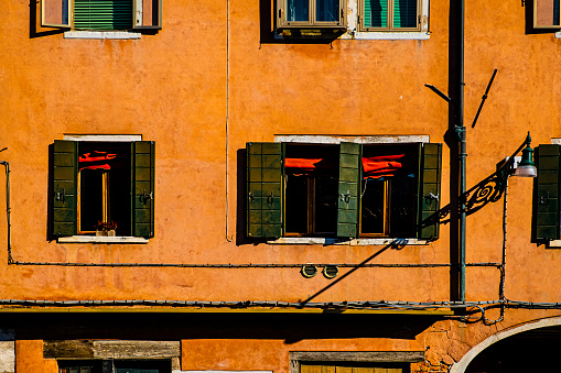 Italian culture on Venetian facades. Venice is rich and poor, well-groomed and abandoned, reflected in its windows.