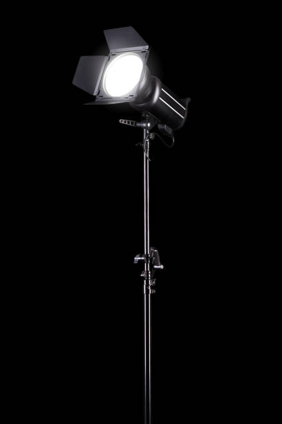 istock Photography studio flash on a lighting stand isolated on black background. 1269635980