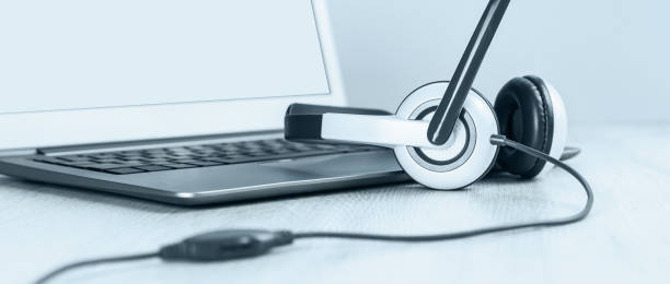 istock Laptop with headphones on white desk 1269638581