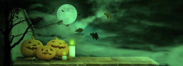 istock Halloween background. Pumpkins on a wooden table 1269639545