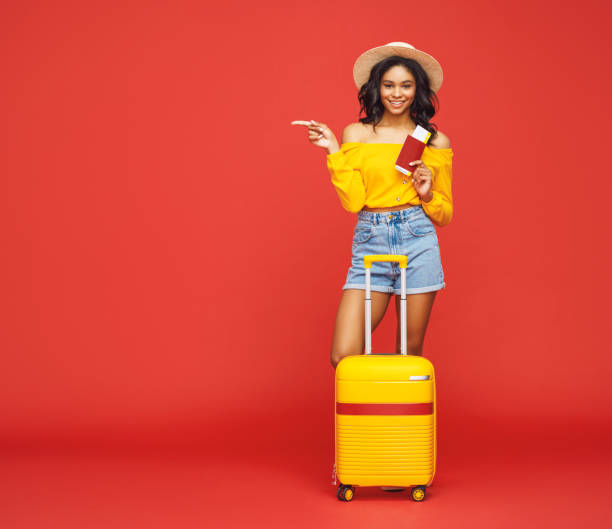 istock Ethnic tourist with luggage pointing away 1269639572