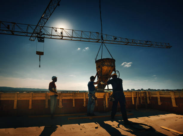 istock Construction workers finishing rooftop wall on the apartment building. 1269645404