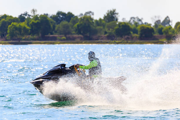A man ride jet ski in the river with water splash. stock photo