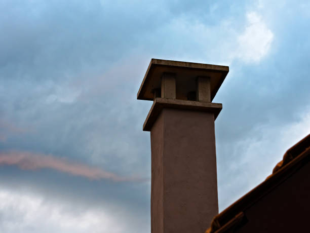 istock Cement chimney on a house roof 1269646994