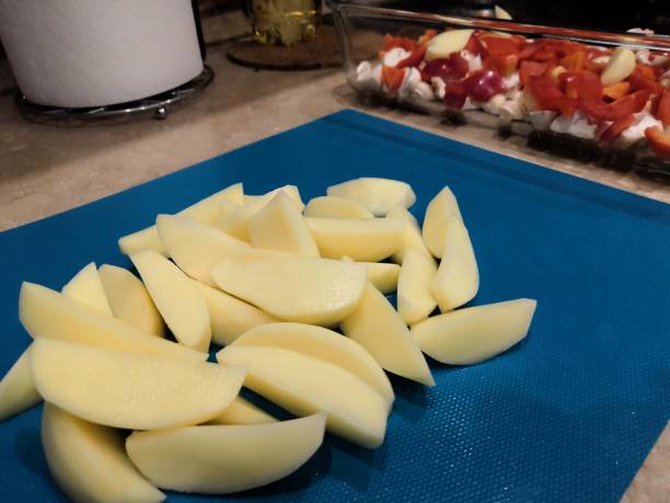 istock country-style sliced potatoes for baking in the oven, step-by-step process of cooking a vegetable dish 1269647632