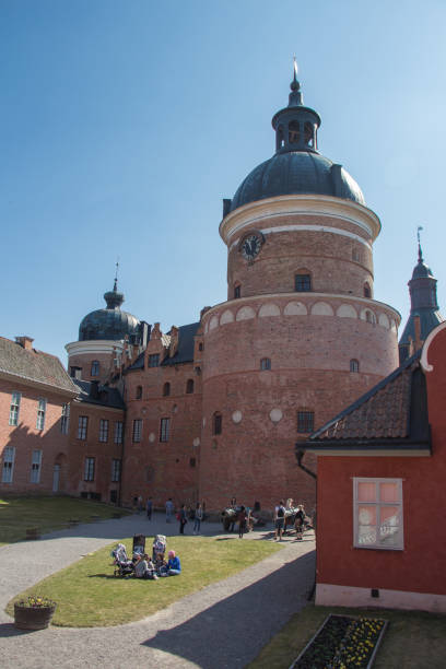 Interior courtyard of Gripsholm Castle in a sunny day, Mariefred, Sweden. Mariefred, Sweden - April 20 2019: the view of tourists in the interior courtyard of Gripsholm Castle on April 20 2019 in Mariefred, Sweden. mariefred stock pictures, royalty-free photos & images