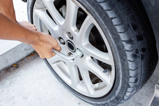 istock Man changing tire with wheel wrench 1269649479