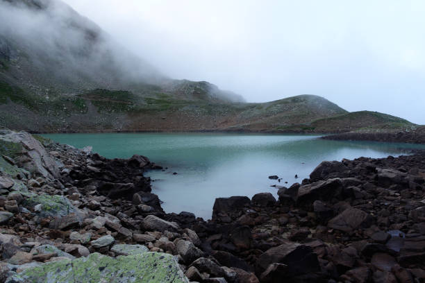 istock Alpine lake in the clouds. 1269650960
