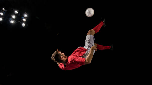 istock Football player  in mid-air performing a bicycle kick 1269652752
