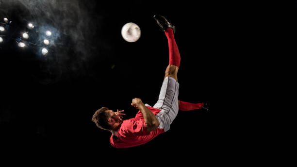 istock Football player  in mid-air performing a bicycle kick 1269652753