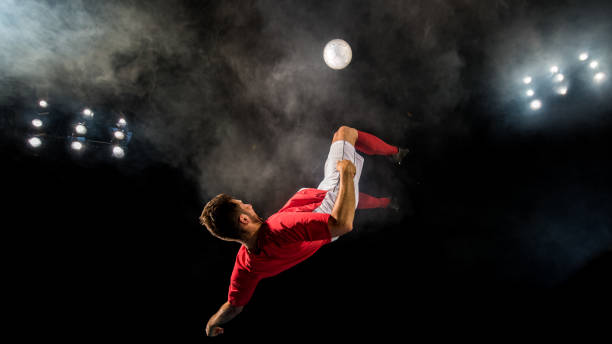 istock Football player  in mid-air performing a bicycle kick 1269652759