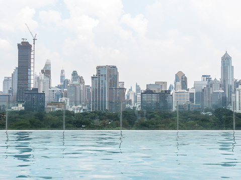Beautiful view of the city of Bangkok in Asia from infinity swimming pool near Lumpini park