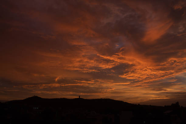 Beautiful clouds above the hill during the sunset
