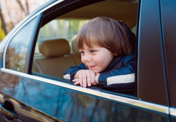 istock Baby boy in the black car with beige interior. 1269656065