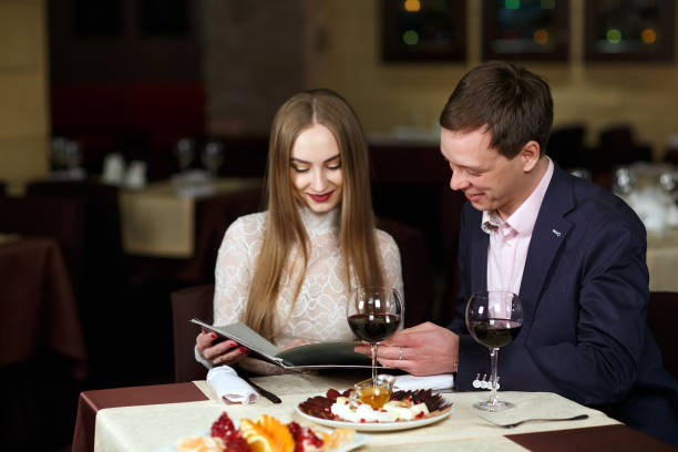 istock Cheerful couple with menu in a restaurant. 1269656178