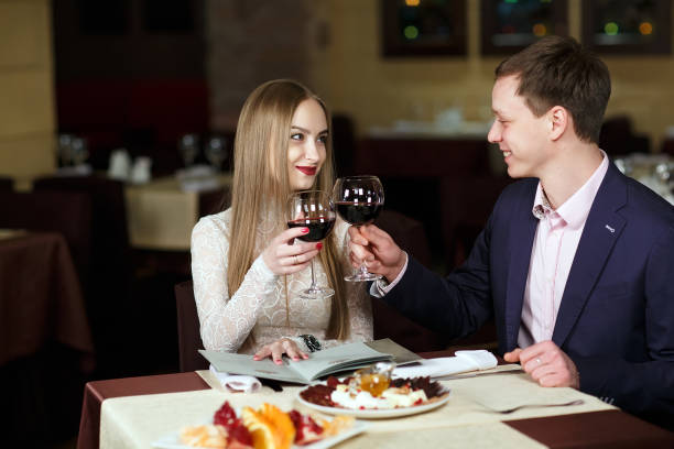 istock Cheerful couple with menu in a restaurant. 1269656211