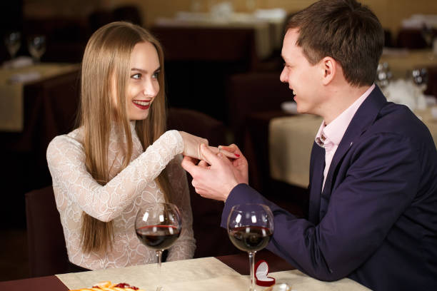 istock Marriage proposal at a restaurant. Beautiful young couple in a cafe. 1269656487