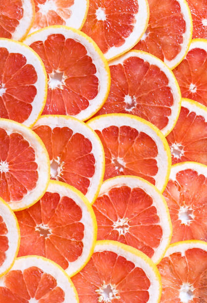 istock Close up of sliced grapefruit as a background 1269660116