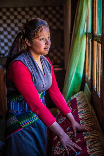 istock Tibetan young woman looking through the window, Upper Mustang, Nepal 1269660340