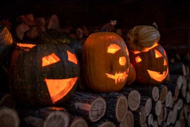 istock Three terrifying pumpkins with faces left on firewood on Halloween 1269662083