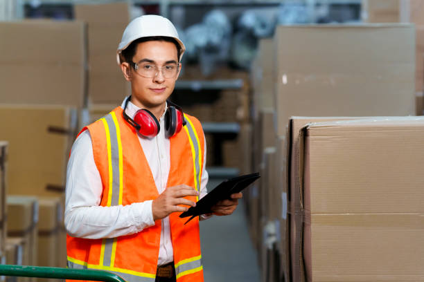 istock Young manager of a logistics warehouse stands with a tablet in his hands 1269663884