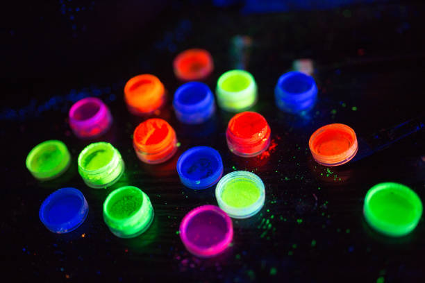 istock Multicolored UV powder in containers on the black background. 1269663939