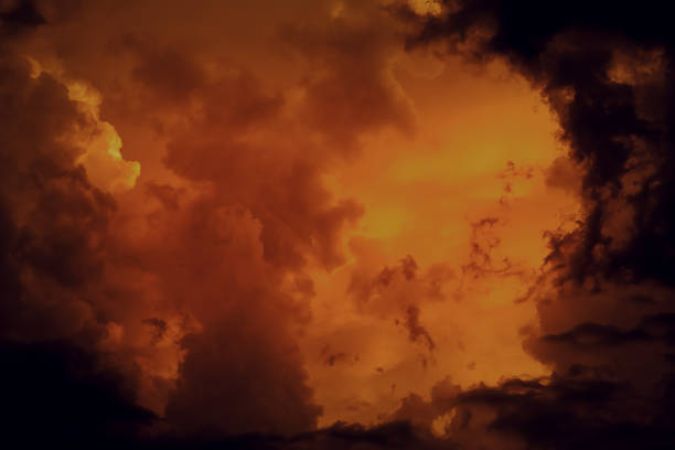 Fantastic concept mystical horror background from another planet from the paranormal world, fantasy style. Dramatic red black orange sky with scary hellish clouds and terrible shadows and light