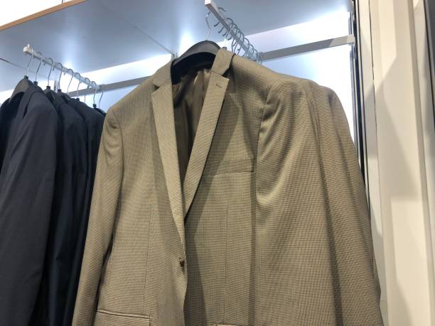 istock Men coats hanging in a cloth market 1269665229