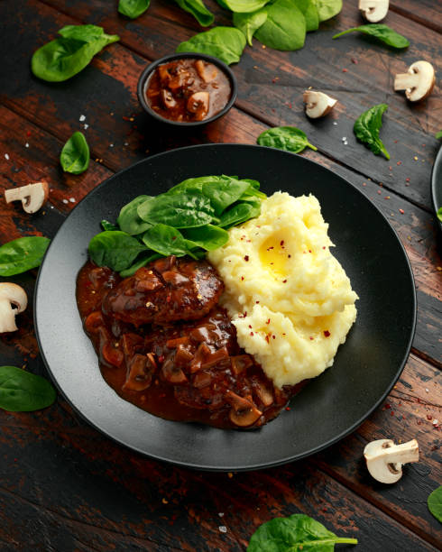 istock Salisbury Steak with mushroom gravy, mashed potatoes and spinach 1269665338