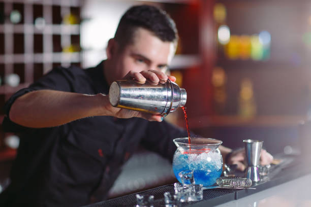 istock Bartender pouring fresh cocktail in fancy glass. 1269667801