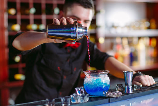 istock Bartender pouring fresh cocktail in fancy glass. 1269667812