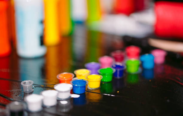 istock Tattoo ink poured into small caps on the black table 1269668937