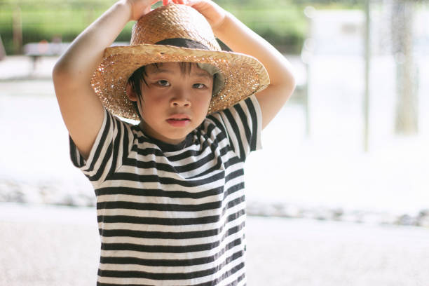 little girl in central park playing with hat