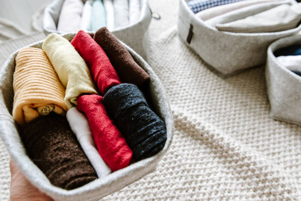 istock Close up of neatly folded and rolled clothes in baskets. 1269670865