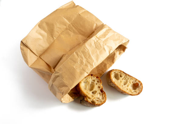 istock Pieces of baguette bread from a paper bag 1269674323