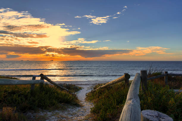 istock Sunset over Indian Ocean with sandy beach and shrubs, Western Australia coastline. Perth. 1269674332