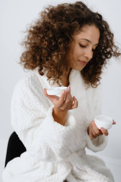 istock Young afro american woman in bathrobe at bathroom 1269676853