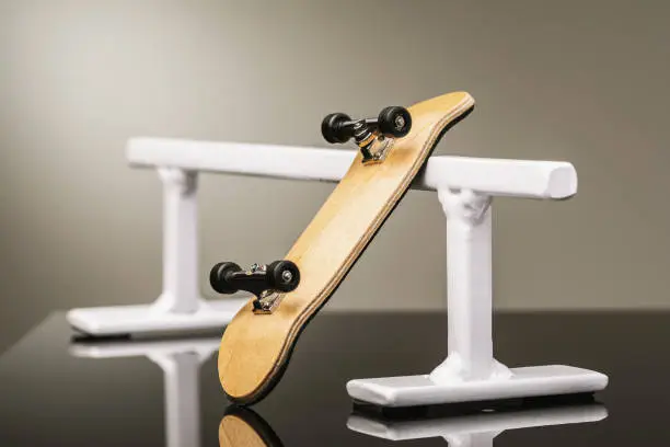 Photo of Fingerboard and white metal railing, close-up