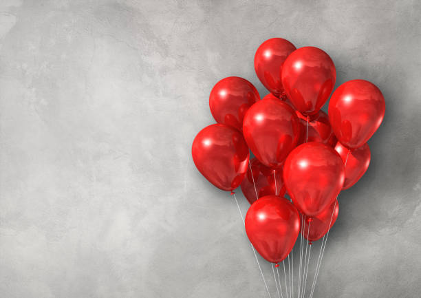 istock Red air balloons group on a light concrete wall banner 1269678005