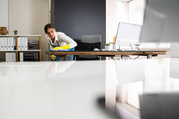 istock Janitor Cleaning Office Desk 1269681698
